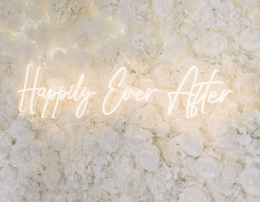 a white flower wall with the words happily ever after